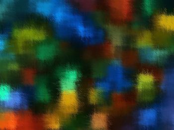 Defocused image of multi colored light painting on wall
