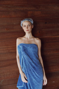 Portrait of young woman standing on hardwood floor