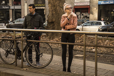 People standing on bicycle in city