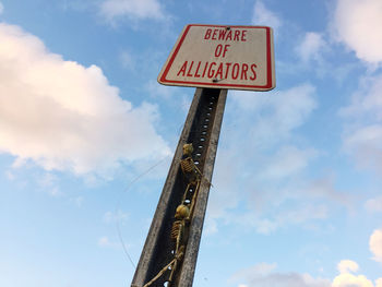 Two skeletons on alligator sign pole 