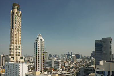 Cityscape with skyscrapers against blue sky