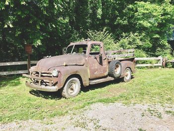 Abandoned vintage car on field