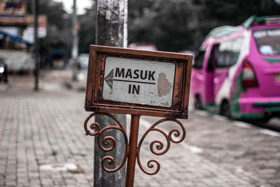 Close-up of information sign on street