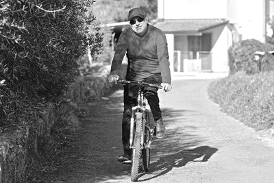 Man riding bicycle on road