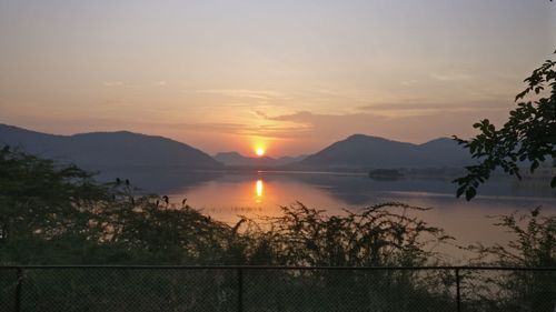 Scenic view of lake against sky during sunset