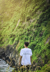 Rear view of man sitting in forest