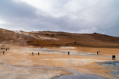 People on landscape against sky