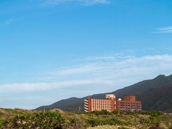 Buildings on mountain against sky