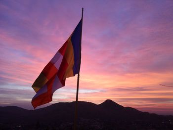 Low angle view of flag against sky during sunset