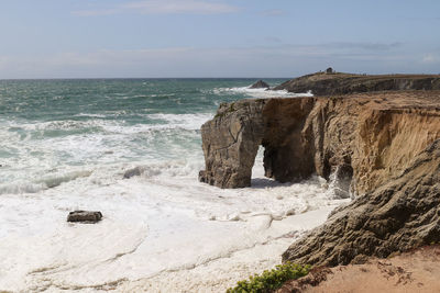 Spectacular cliffs and stone arch arche de port blanc on famous coastline cote sauvage, france