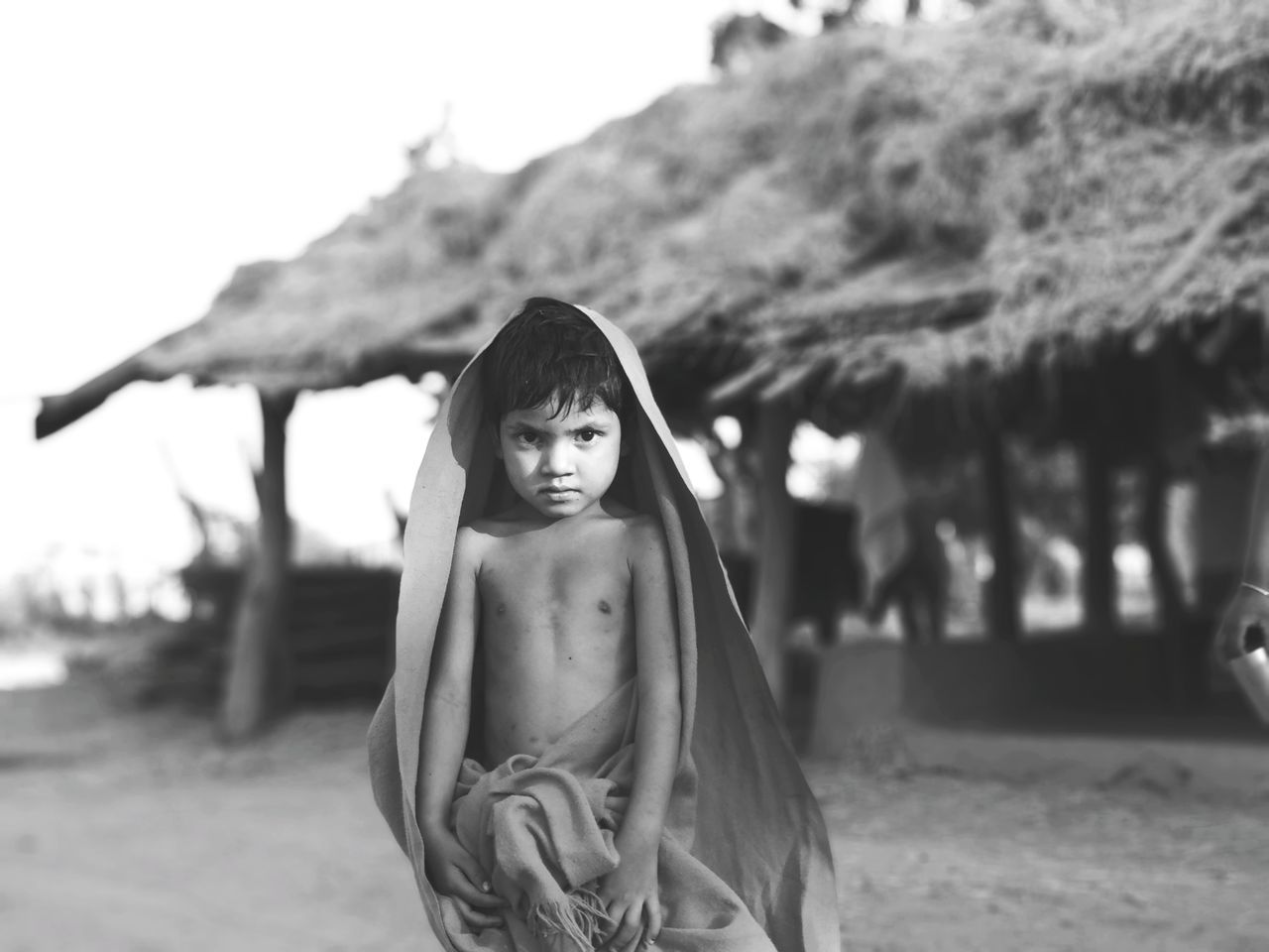 Portrait of shirtless boy standing at beach