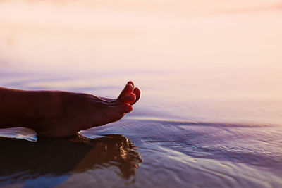 Low section of woman in sea