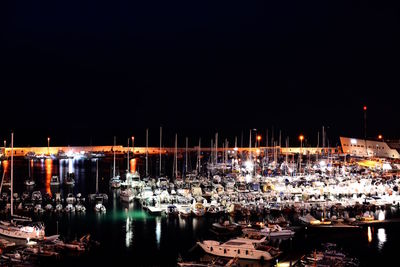 Boats in harbor at night