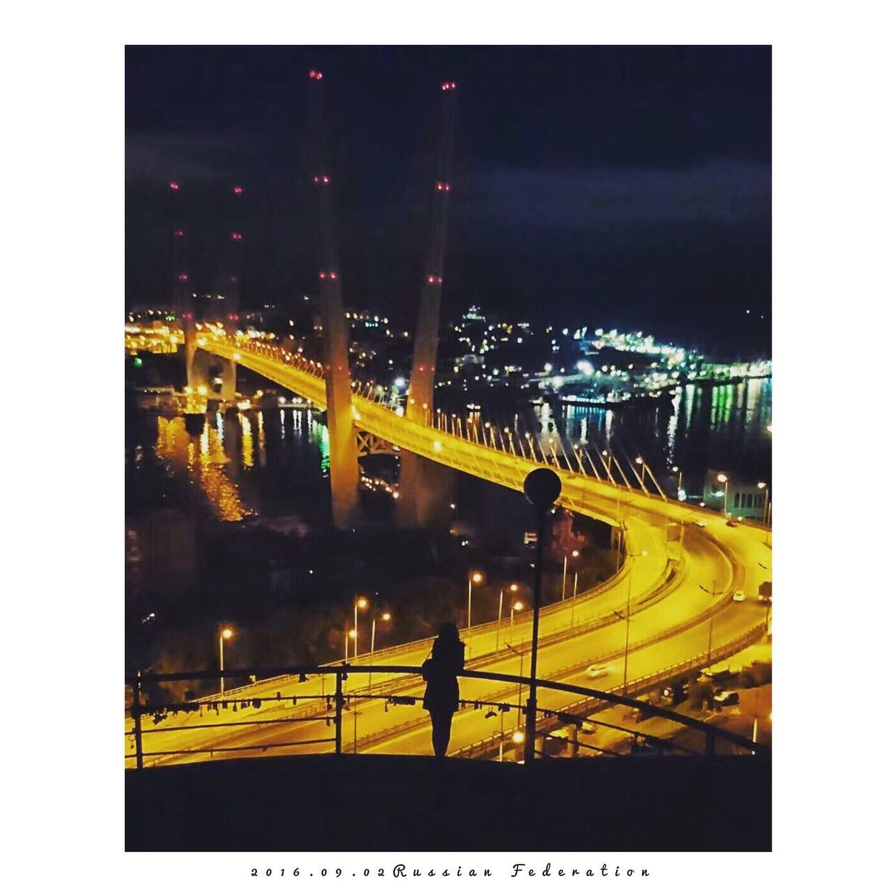 HIGH ANGLE VIEW OF ILLUMINATED CITY STREET AT NIGHT