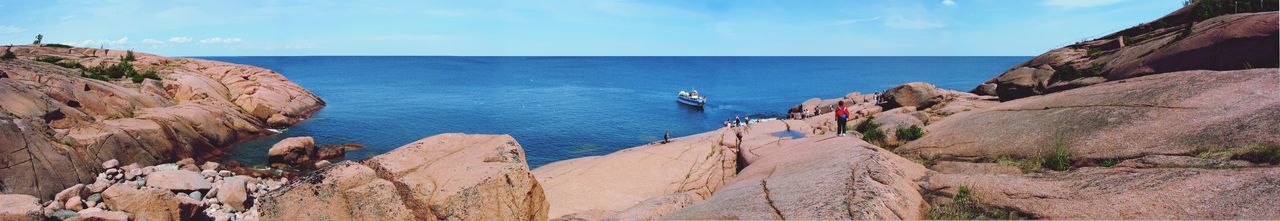 Panoramic view of sea and rocks against sky