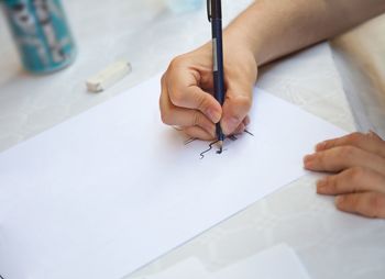Close-up of person drawing on paper
