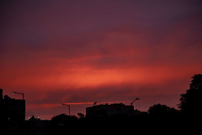 Low angle view of silhouette buildings against sky during sunset