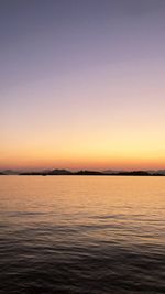 Scenic view of sea against clear sky during sunset