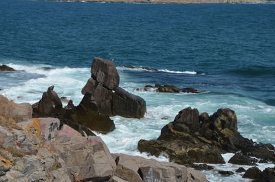 Rocks on shore by sea