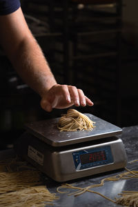 Cropped hand of person preparing food on table