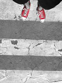 Low section of man standing on zebra crossing