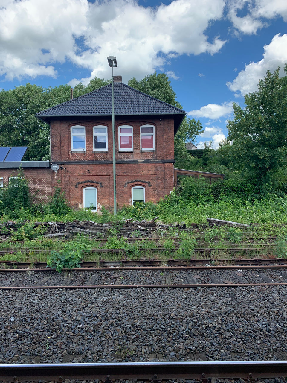 VIEW OF RAILROAD TRACKS BY BUILDING