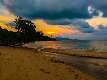 Scenic view of beach against sky during sunset