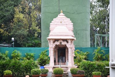 Statue in front of temple against sky
