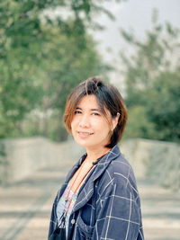 Portrait of smiling young woman standing outdoors