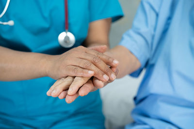 Midsection of doctor examining patient in hospital