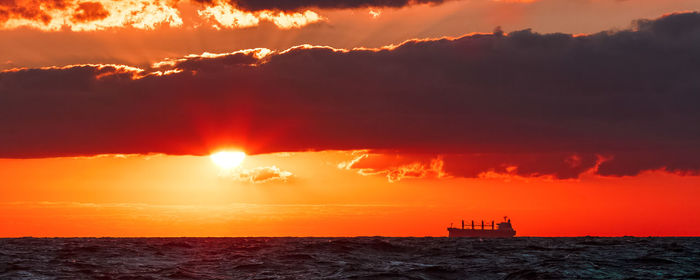 Scenic view of sea against orange sky
