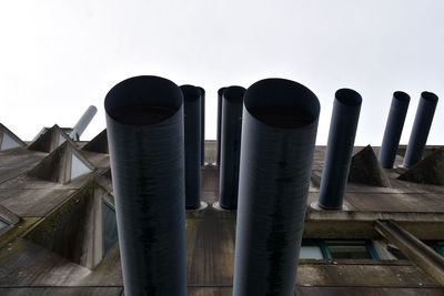 Low angle view of pipes against clear sky