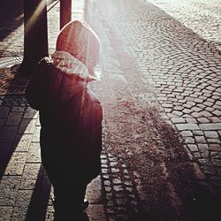 Woman standing on footpath