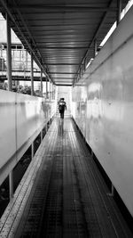 Rear view of people walking at railroad station