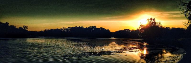 Scenic view of lake at sunset