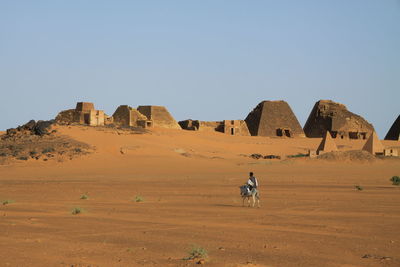 Tourists riding horse in a desert