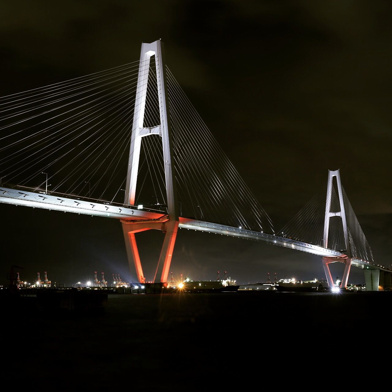 night, illuminated, suspension bridge, built structure, connection, engineering, bridge - man made structure, architecture, sky, transportation, metal, travel destinations, low angle view, cable-stayed bridge, development, city, travel, famous place, river, capital cities