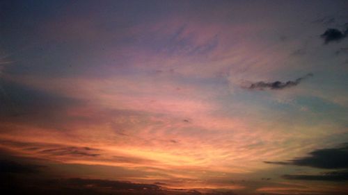 Low angle view of cloudy sky at sunset