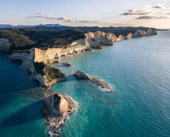 Panoramic view of sea and rocks against sky