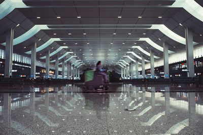 Rear view of man standing on tiled floor