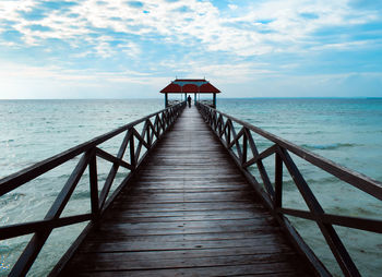 Pier over sea against sky