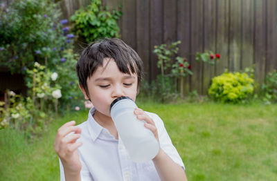 Boy holding plant