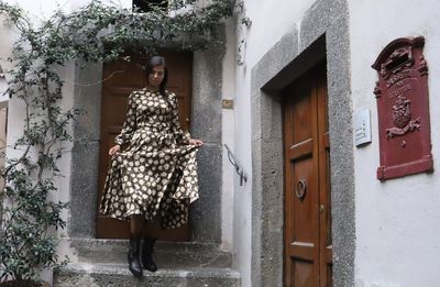 Woman standing at entrance of building