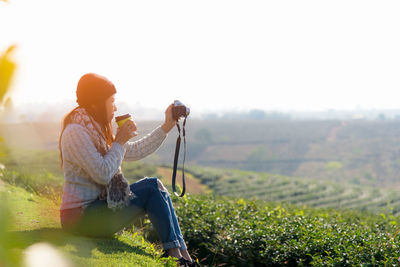 Woman sitting on field