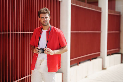 Portrait of young man photographing