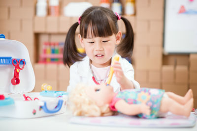 Portrait of cute girl sitting at table