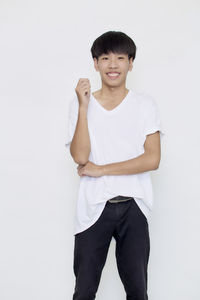Portrait of smiling young man against white background