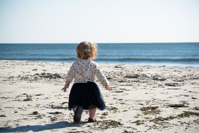 Rear view of boy on beach