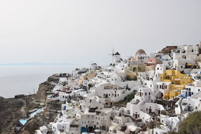 High angle view of townscape by sea against sky