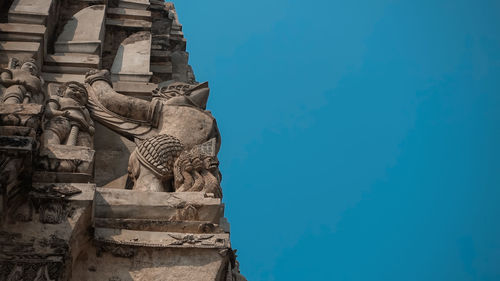 Low angle view of statue against blue sky